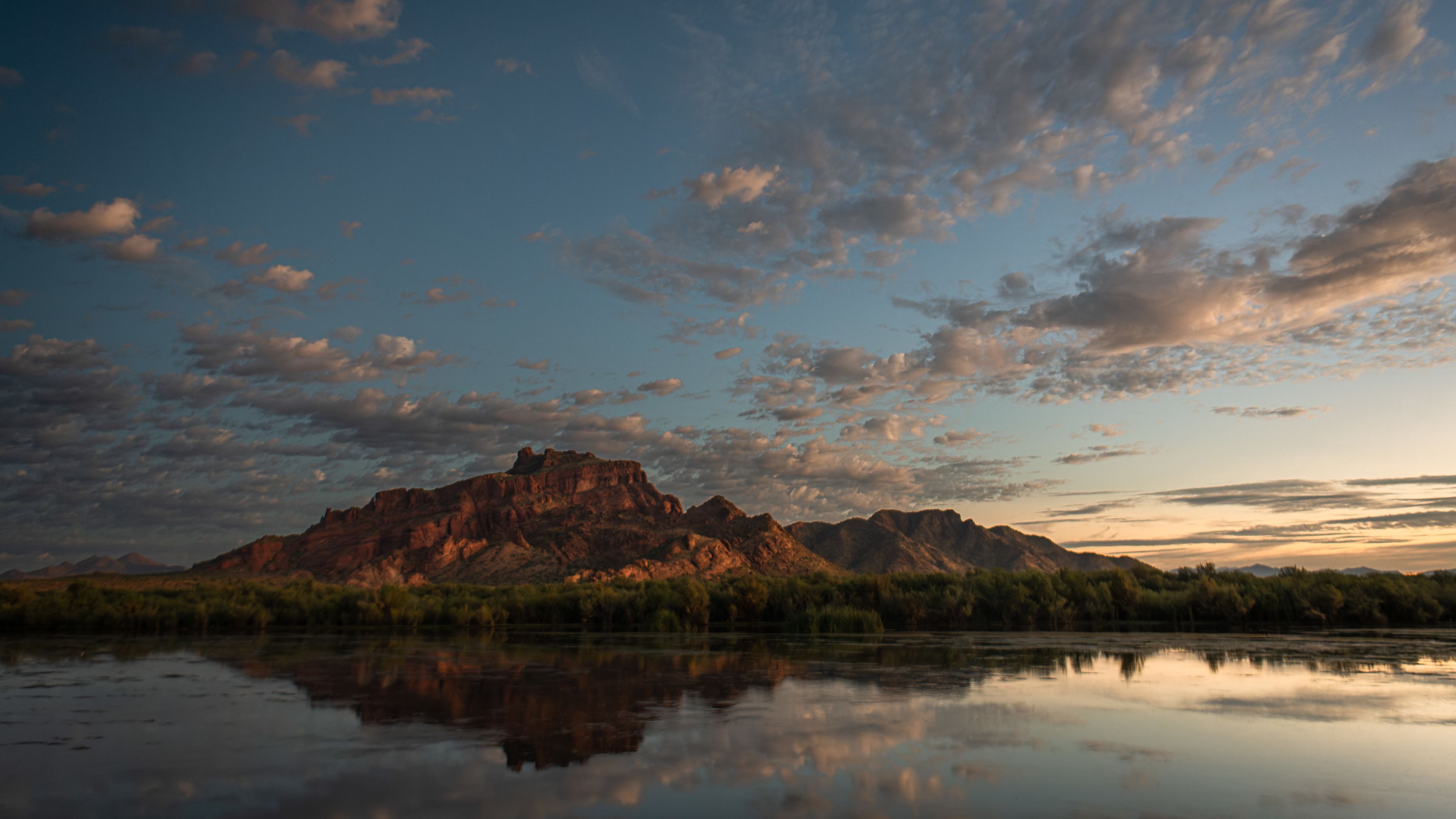 Red rock mountain reflected in water